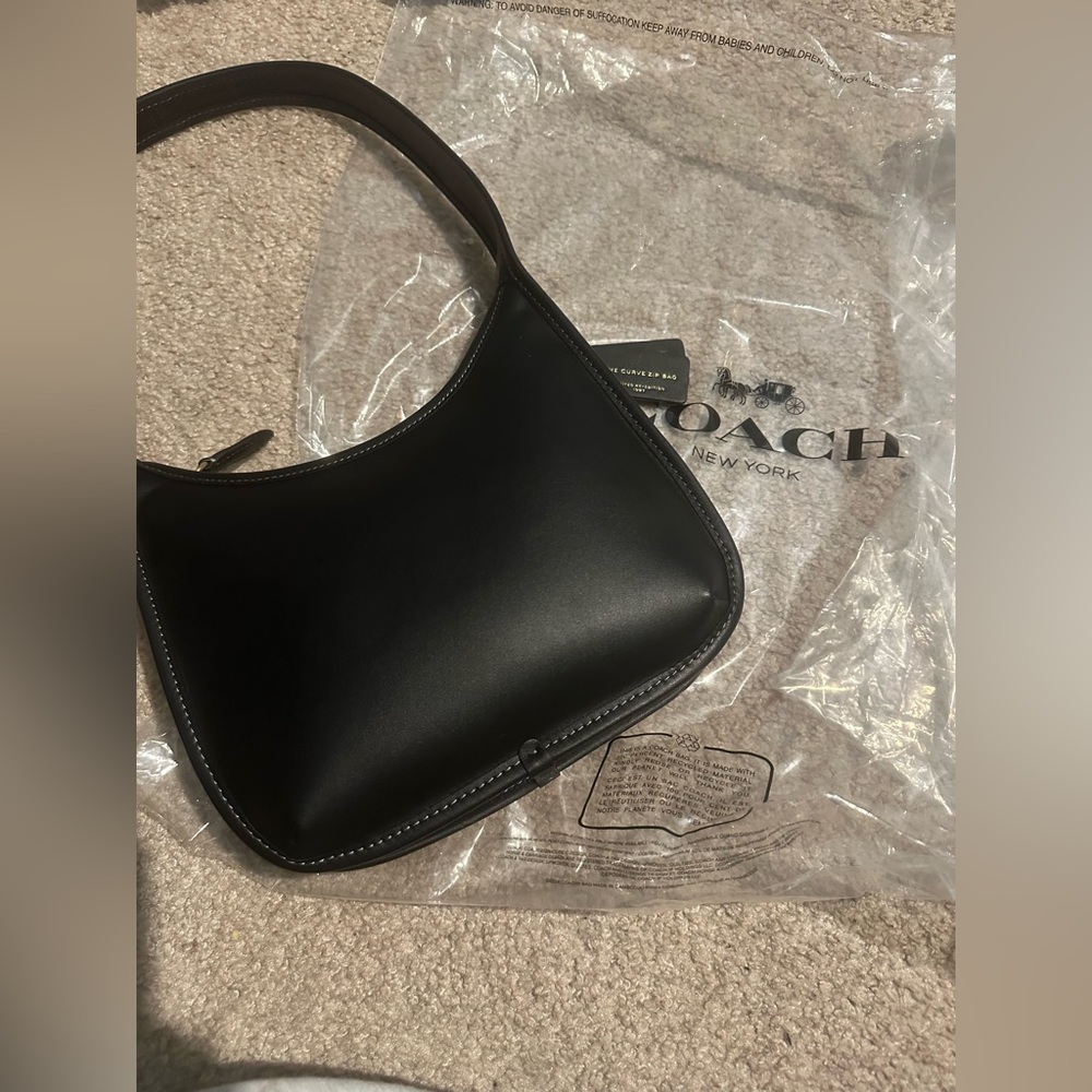 Coach limited re-edition of 1997 curve zip bag. Black. Never worn. W/dust bag.